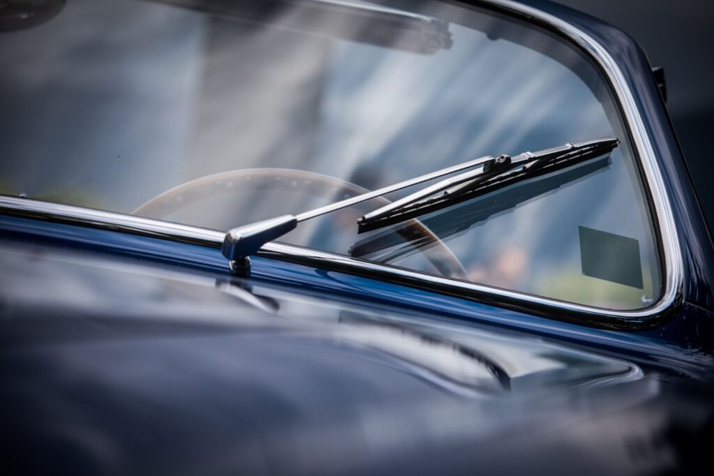 Close up of a classic car windshield, showcasing vintage design and craftsmanship