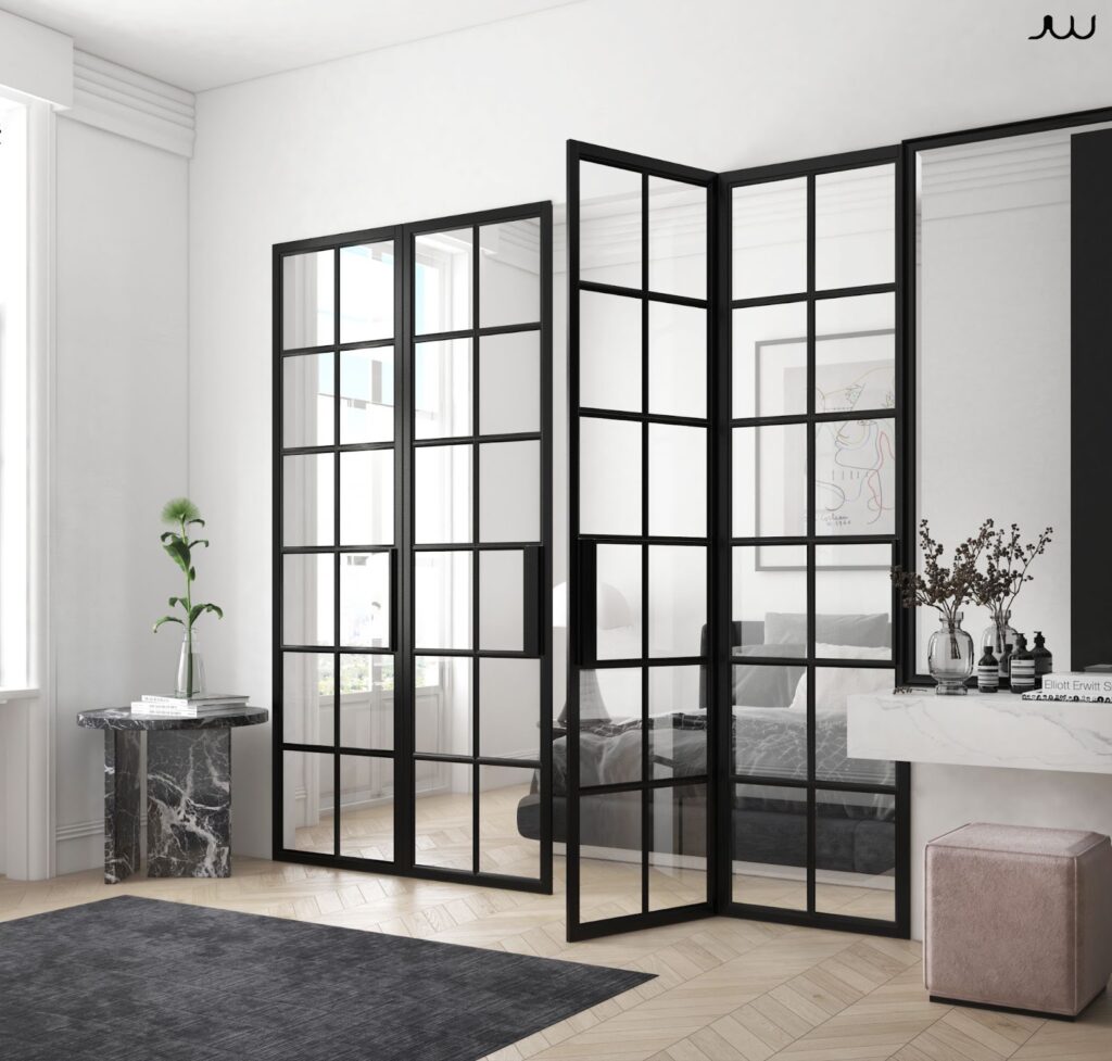 Bedroom featuring black glass doors and a mirror